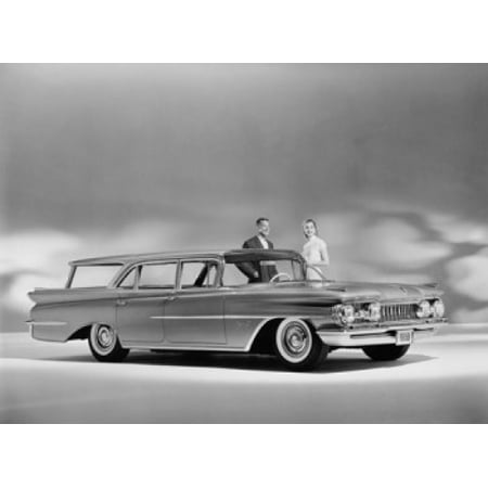 Man and a woman standing near a 1959 Oldsmobile Super 88 Fiesta Canvas Art - (18 x 24)