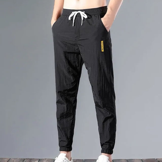 Pantalones casuales de moda para hombre, con bolsillos y tobillos, color liso, cintura elástica y cordón ajustable.