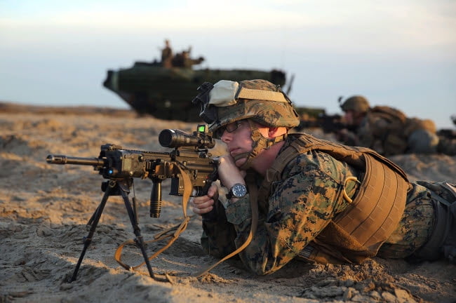 US Marine provides security with his M16 service rifle on Red Beach ...