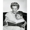 Portrait of son sitting on his mothers lap reading book Poster Print