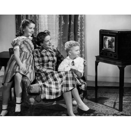 Mid adult woman with son and daughter watching television Canvas Art -  (24 x 36)