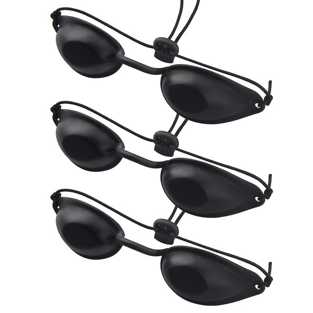 gafas de seguridad ultravioleta 3 piezas, gafas de solárium negras tipo copa con lentes ovaladas de silicona de superficie lisa, correas elásticas ajustables con cierre deslizante y estuche transparente; diseñadas para protección UV e infrarroja durante tratamientos y aptas para transporte.