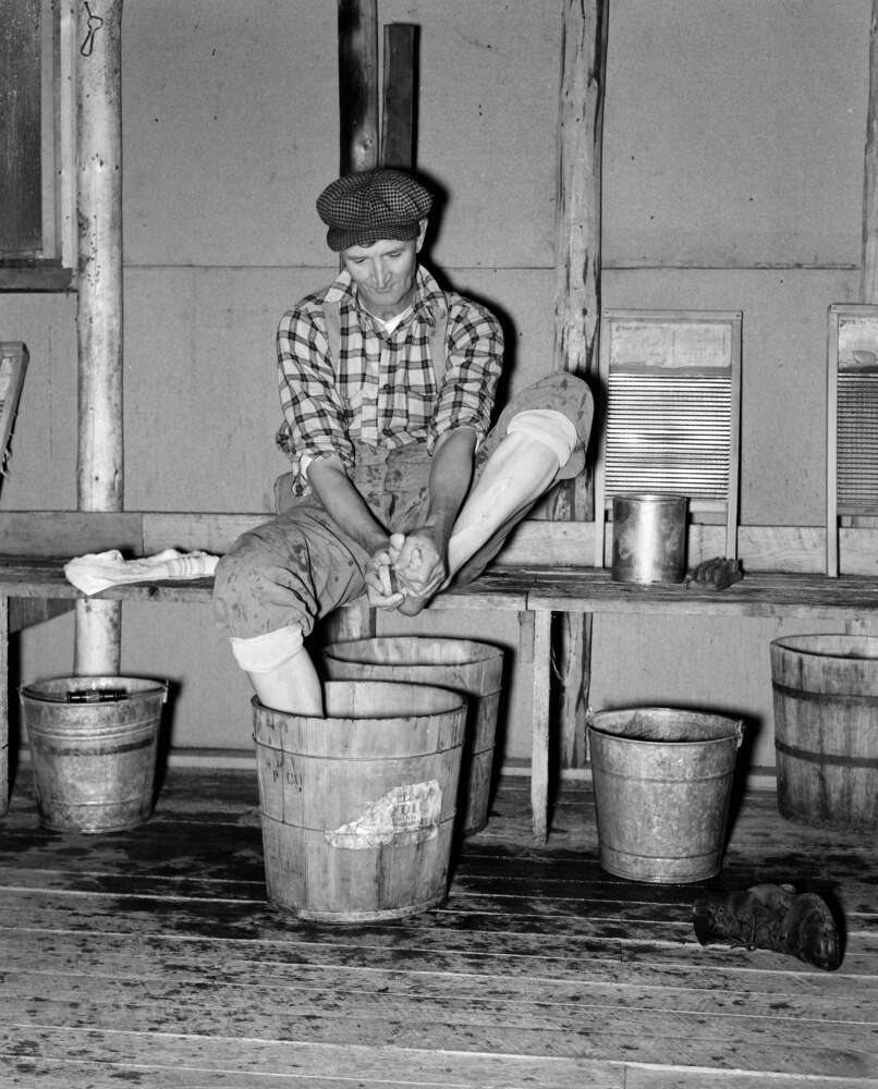 Minnesota Lumber Camp, 1937. /Na Lumberjack Washing His Feet In A