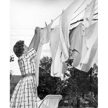 Young woman hanging clothes on a clothesline Stretched Canvas - (24 x 36)