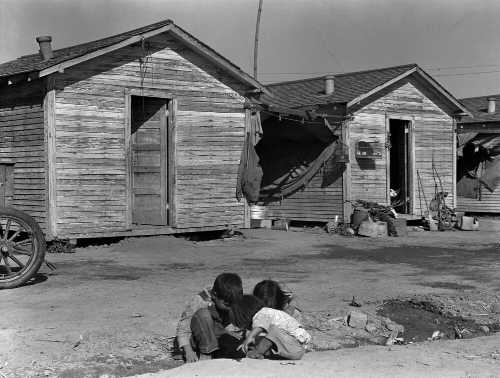 Migrant Housing, 1936. /Nchildren Playing In Front Of Housing For