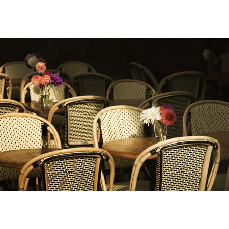 Paris Bistro Chairs A bouquet of flowers amongst empty parisian bistro chairs and tables Paris France Canvas Art - Philippe Widling Design Pics (40 x 26) ()