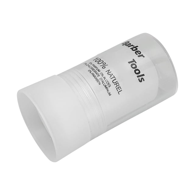 Alum Stick, Portable Skin Soothing After Shave Block 3.5oz for Home Hair Salon. A cylindrical alum stone stick encased in a clear plastic container with 'Barber Tools' and '100% Naturel' printed on the surface. Designed to soothe skin, reduce redness, and stop minor bleeding from shaving nicks. Compact and suitable for personal or professional use.