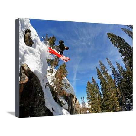 Skier Jumping Off Small Cliff at Brighton Ski Resort Stretched Canvas Print Wall Art By Paul