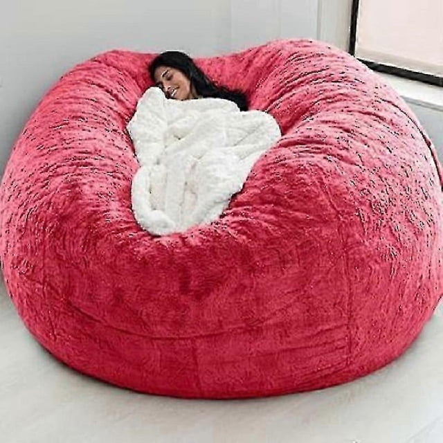 2025 new extra large bean bag chairs couch sofa cover indoor lazy lounger for adults kids without chair-bbc extragrande; vista frontal centrada de un puff redondo tipo donut con superficie de felpa y costuras en paneles, persona recostada parcialmente cubierta por una manta blanca. Tejido de algodón y lino según ficha, cremallera oculta en el borde, apto para sala o dormitorio y a menudo usado como lugar de lectura o zona de juego.