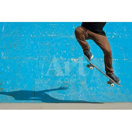 Skateboarder Doing a Skateboard Trick - Ollie - at Skate Park. Print Wall Art By