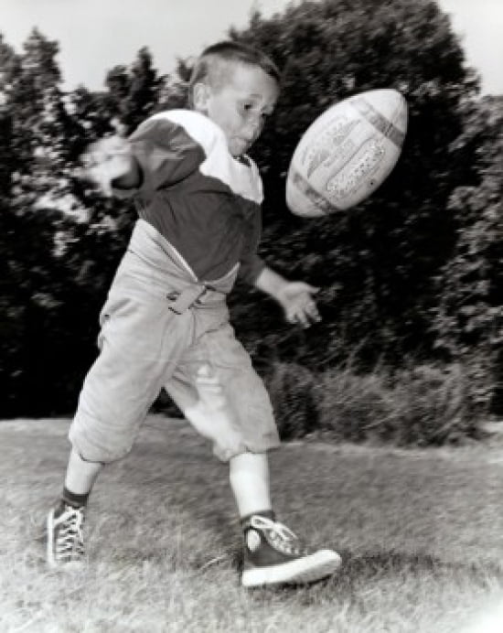 Boy Kicking A Footb