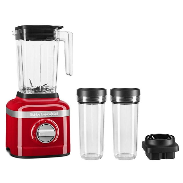 KitchenAid 3 speed ice crushing blender in red with clear blending pitcher, two personal-sized blending jars, and a blade assembly.