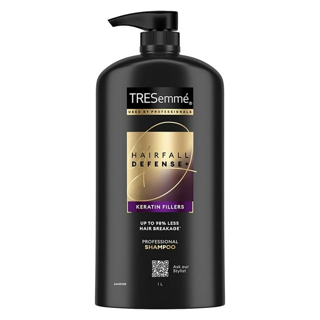 Tresemme Hair Fall Defence Shampoo with Keratin Fillers, professional shampoo in a 1-liter black bottle with pump dispenser. The gold-accented label highlights keratin-enriched formula for reducing hair fall due to breakage, strengthening hair, and promoting longer, stronger strands. Suitable for daily use and Indian hair care routines.