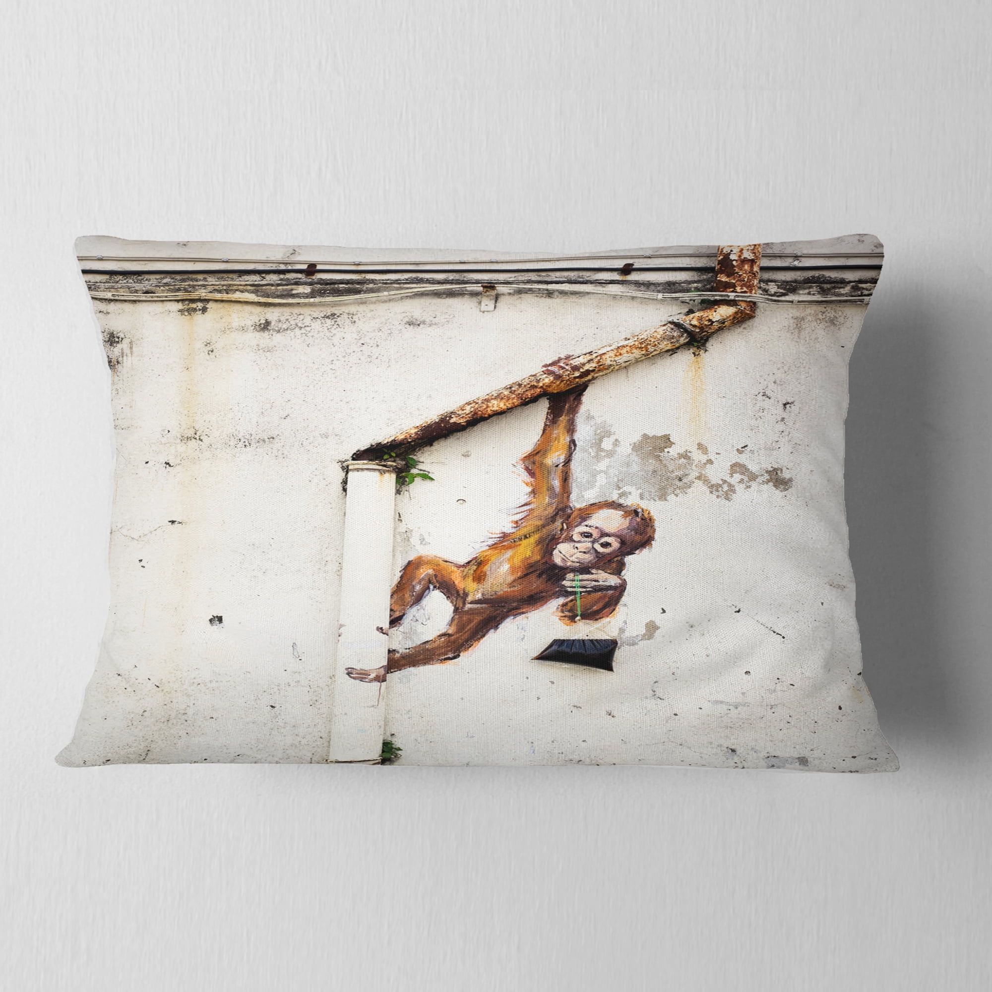 Designart Baby Orangutan Hanging from Pipe - Street Art Throw Pillow - 12x20