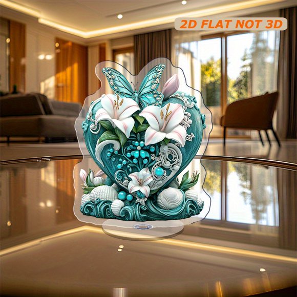 Rotating acrylic ornament featuring a blue-green heart adorned with white and pink lilies, blue pearls, turquoise shells, and a butterfly with lace wings