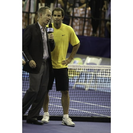 Pete Sampras and John McEnroe on a tennis court Photo