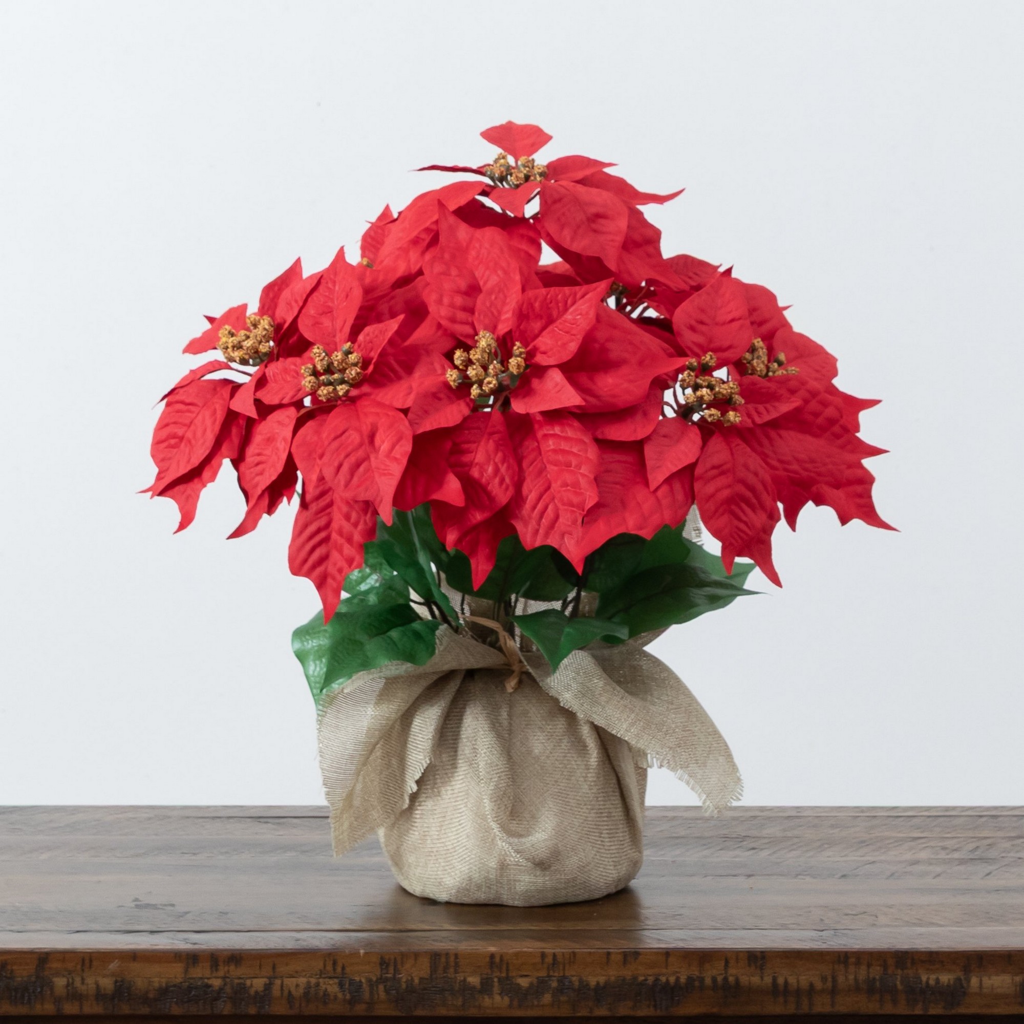 16in. Artificial Poinsettia Arrangement in Burlap Planter