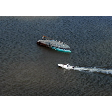 LAMINATED POSTER In this aerial photograph, a capsized boat is seen adrift in Galveston Bay. Hurricane Ike struck the Poster Print 24 x