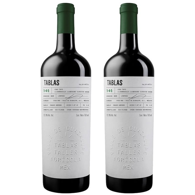 vino tinto 2 pack 750ml tablas taller agrícola Dos botellas frontales con cuello verde y etiqueta blanca en relieve que muestra TABLAS TALLER AGRÍCOLA; 750 ml cada una, blend Tempranillo‑Grenache‑Petit Syrah de Valle de Guadalupe, crianza 12 meses en barrica francesa, color rojo violáceo; maridaje sugerido con barbacoa o cordero; ideal para regalar en cenas.