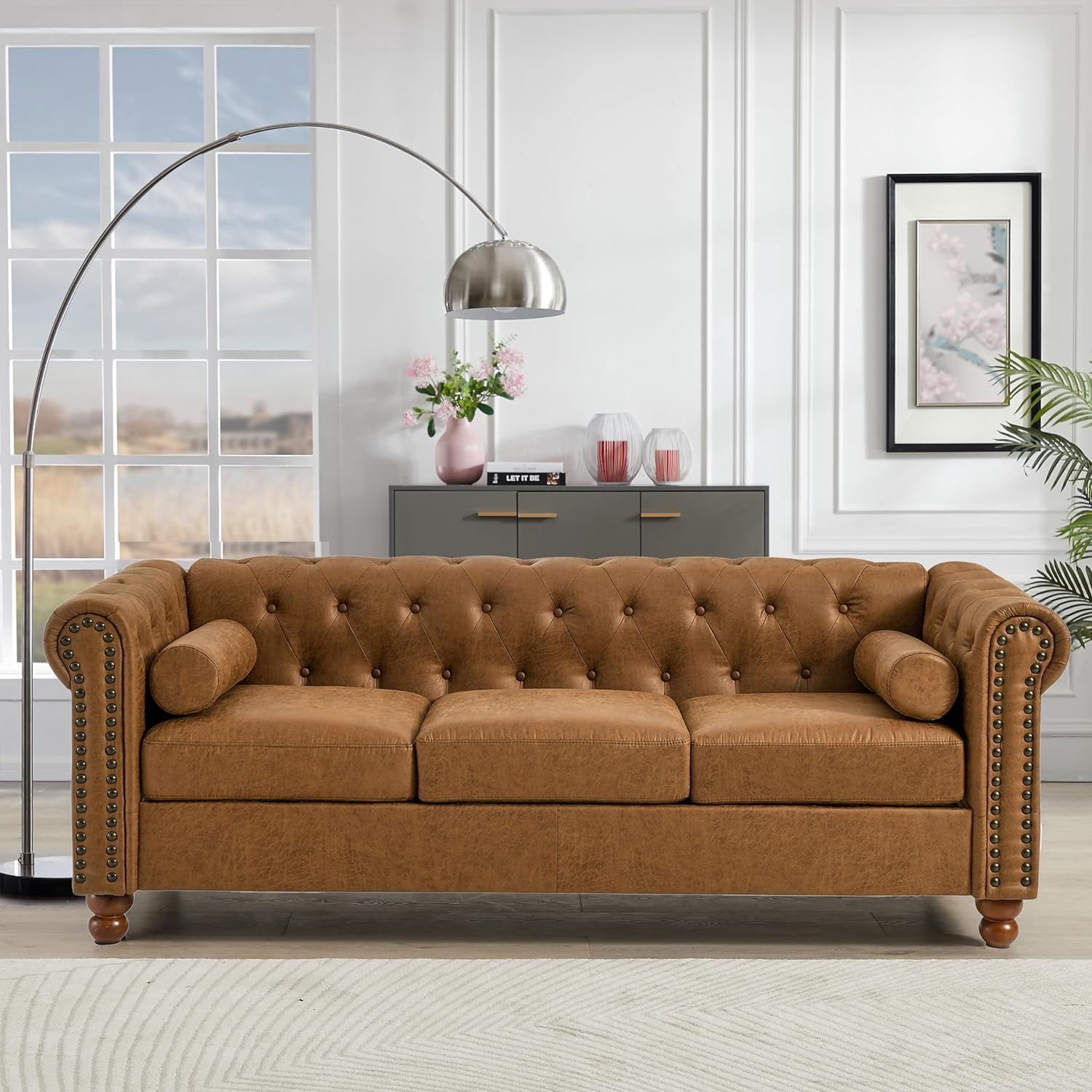 Luxurious Air Leather Chesterfield Sofa, 3-Seater with Rolled Arms, Tufted Design, Nailhead Accents, and Neck Roll Pillows for Cozy Living Spaces