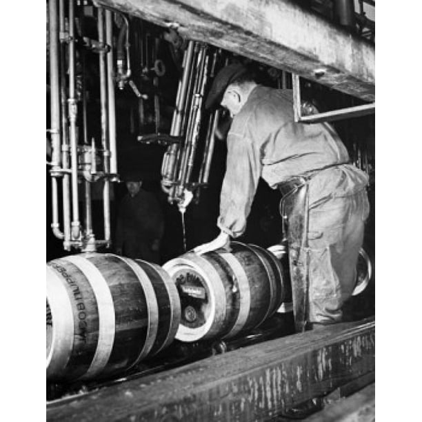 Manual workers working on a machine in a distillery Rupperts Brewery