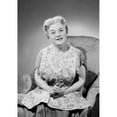 thumbnail image 2 of Portrait of senior woman sitting in armchair, studio shot Poster Print (18 x 24), 2 of 4