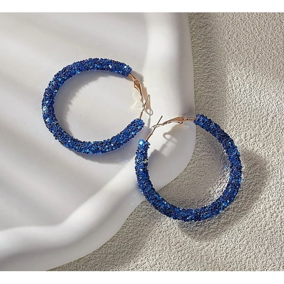 Pierced 2 1/4" gold and blue glitter hoop earrings