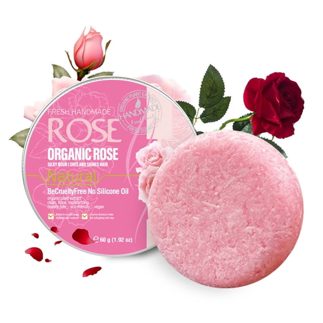 jabón de rosas jabón de aceite jabón de baño limpiador jabón de rosas jabón limpiador barra de champú rosa Jovati, vista frontal centrada de una pastilla redonda rosa junto a su empaque redondo rosa con texto 'ROSE' y flores decorativas, superficie fibrosa y sólida visible, contenido 60 g, a menudo usada como champú en barra para limpieza diaria y cuidado del cuero cabelludo.