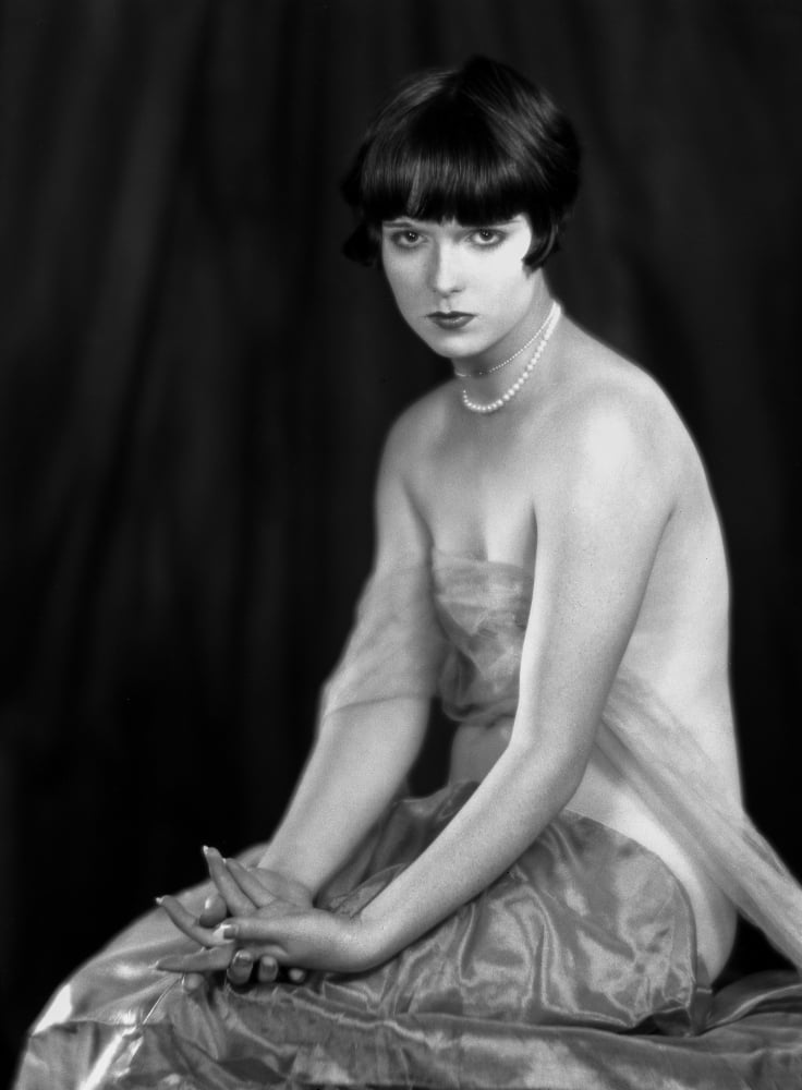 Louise Brooks sitting in Sexy Dress with Black Background Louise Brooks sitting in Sexy Dress with Black Background