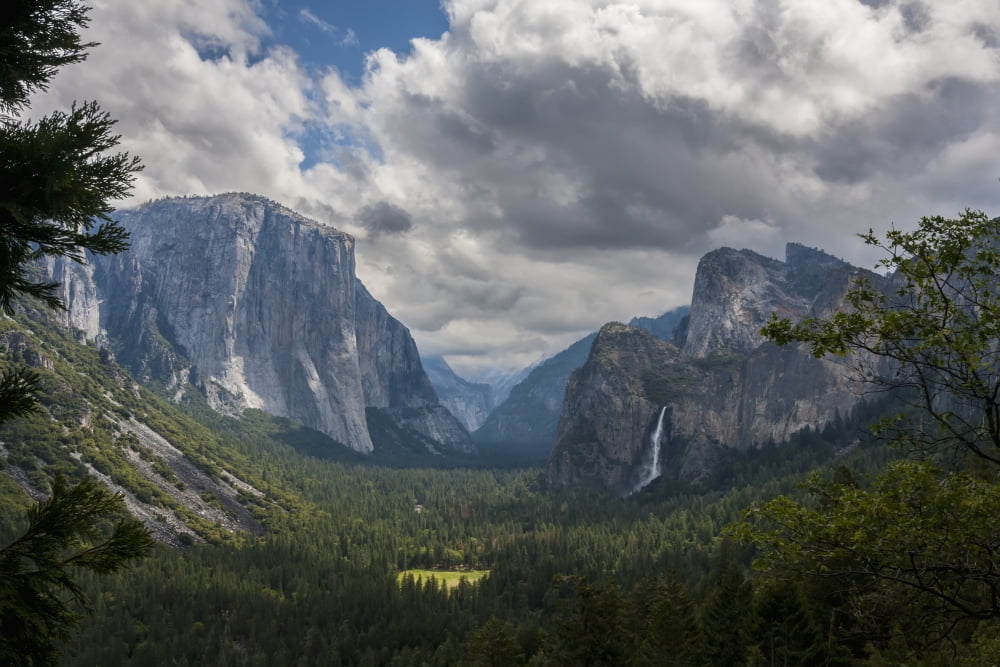Clouds move over Yosemite Valley with Bridalveil Falls on the right and El Capitan on the left Yosemite National Park California United States of America Canvas Art - Tracy Barbutes Design Pics (19 x