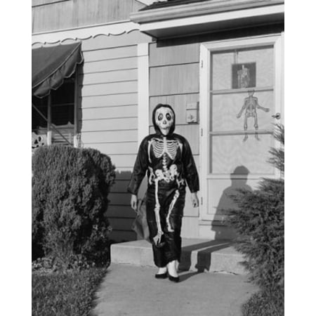 Person wearing a Halloween costume walking on a footpath outside a house Poster Print