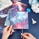 thumbnail image 4 of Bloc de papel con 12 diseños, paquete de 24 hojas de papel de una sola cara con temática de cielo estrellado, fondo de álbum, cartulina y papel para manualidades., 4 of 7