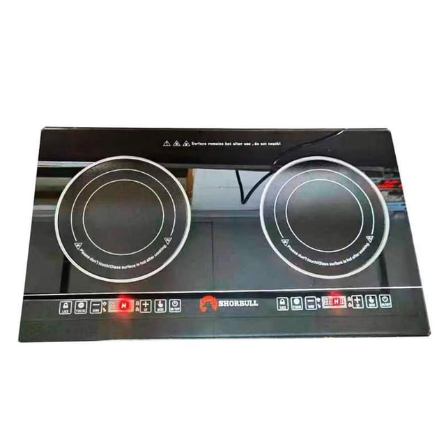 parrilla eléctrica empotrable shorbull 2 quemador vidrio negro, vista frontal cenital con dos zonas de cocción circulares en vidrio templado y anillos blancos, franja inferior con controles táctiles, perillas y pantalla LED roja, logotipo Shorbull centrado, tamaño 72x52x7 cm; también suele usarse como superficie de cocción portátil en espacios pequeños.