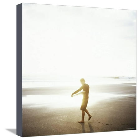 Young Man Waxes His Board Before Entering Marabella's Waves, Costa Rica, Central America Stretched Canvas Print Wall Art By Aaron