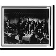 thumbnail image 2 of Historic Framed Print, [Fats Domino, singing, seated at piano, accompanying band at right, at a Greenwich Village night club, audience seated at tables in foreground, in scene from, 17-7/8" x 21-7/8", 2 of 9