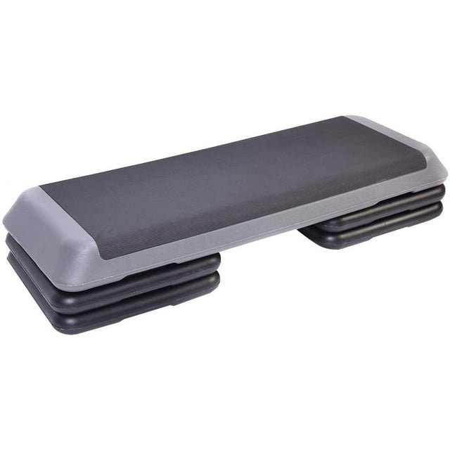 Stanz Adjustable Aerobic Step Platform with 4 Risers, measuring 42.5 x 16 x 4 inches, in black. The stepper features a durable plastic construction with a non-slip surface for safety and stability. It offers three adjustable height levels of 4, 6, and 8 inches, making it suitable for varied workout intensities. Designed for cardio, toning, and fitness exercises, it supports up to 330 lbs and is lightweight for easy transport and storage.