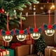 thumbnail image 1 of Adornos navideños con campanas de terciopelo rojo y lazos de hierro forjado para crear un ambiente festivo., 1 of 5