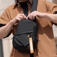thumbnail image 3 of Bolsa pectoral impermeable multifuncional negra para hombre, mochila bandolera de gran capacidad de 31×18×9 cm con correa ajustable, puerto para auriculares y múltiples bolsillos para viajes, 3 of 5