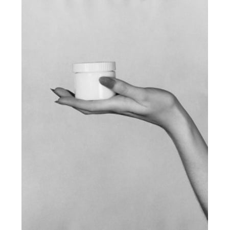 Close-up of a womans hand holding a jar of moisturizer Canvas Art - (18 x 24)