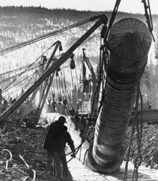 Two construction workers at a construction site of pipeline Trans