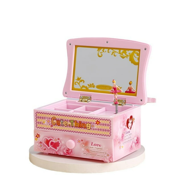 muñeca bailarina con caja de música con espejo y compartimentos para joyas caja musical rosa de PVC 8.1 x 10.2 x 15 cm. Bailarina giratoria que se mueve con la música, tapa abatible con espejo decorado en dorado, varios compartimentos y un cajón para guardar anillos y aretes, acabado rosa suave ideal para tocador.