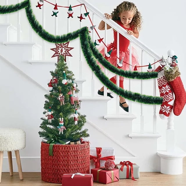 ganfancp guirnalda de la aguja de los pinos de la navidad con la guirnalda artificial verde de la navidad chimenea del invierno decoración del pórtico de la mesa guirnalda de la navidad del cedro ver — guirnalda verde artificial de ramas de pino colgada en la barandilla de una escalera blanca, textura de agujas visible, junto a un calcetín navideño rojo, un árbol de mesa decorado y regalos; adecuada como adorno para chimenea, porche o mesa en temporada navideña.