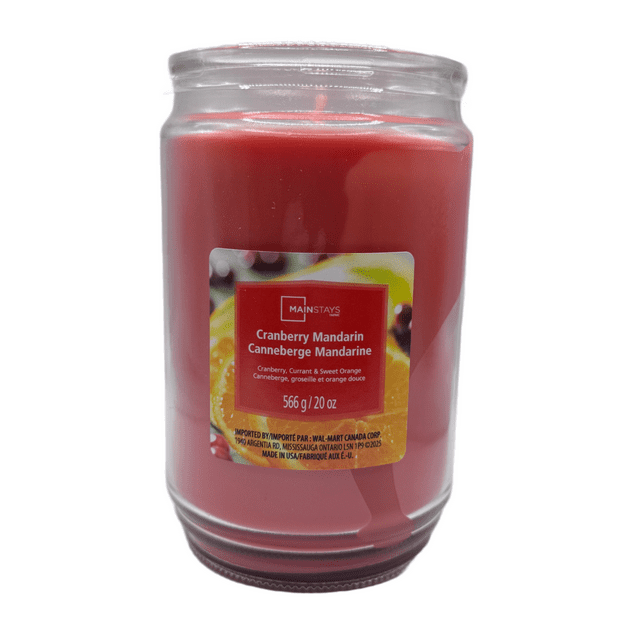 MAINSTAYS Cranberry Mandarin scented single-wick red candle in 20 oz clear glass jar with label featuring cranberry and mandarin fruit.