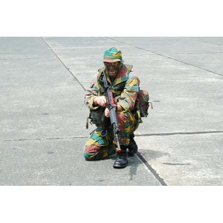 A paratrooper of the Belgian Army training in assault techniques and handling a FN FNC rifle Poster