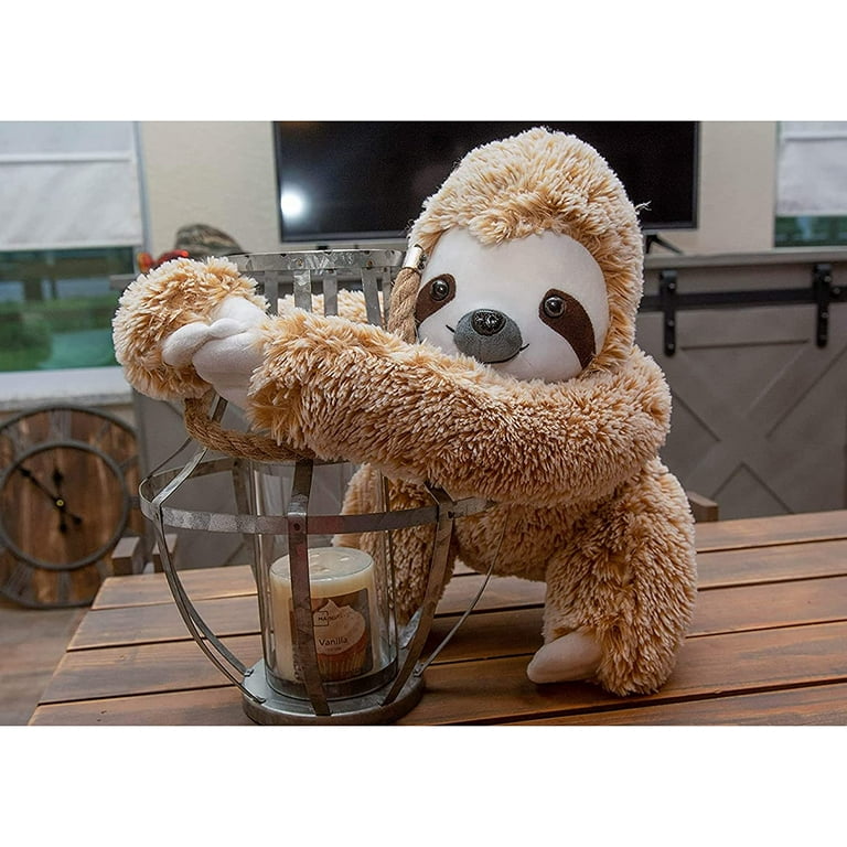 baby sloth hugging stuffed animal