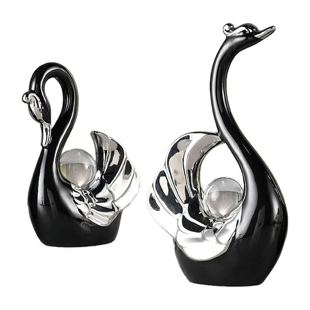 2 figuras de cisne, esculturas, decoración para sala de estar, mesa de café, libro. negro