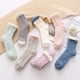thumbnail image 2 of Calcetines de felpa suaves y cálidos pantuflas calcetines para dormir en el piso medias de tubo medio de color sólido para mujer 7 pares Advancent  AP000403-00, 2 of 7
