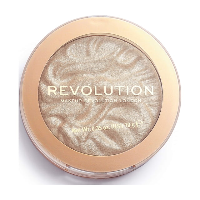 iluminador revolution beauty reloaded just my type, 6,2 ml primer plano centrado de polvo prensado en envase redondo con borde dorado, superficie marmoleada de brillo perlado en tono champán, marca REVOLUTION visible en la tapa; para pómulos y puente de la nariz, suele usarse con pincel húmedo para un acabado más intenso.