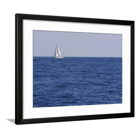 An Expanse of Blue Sea with a Single White Sailboat Framed Print Wall