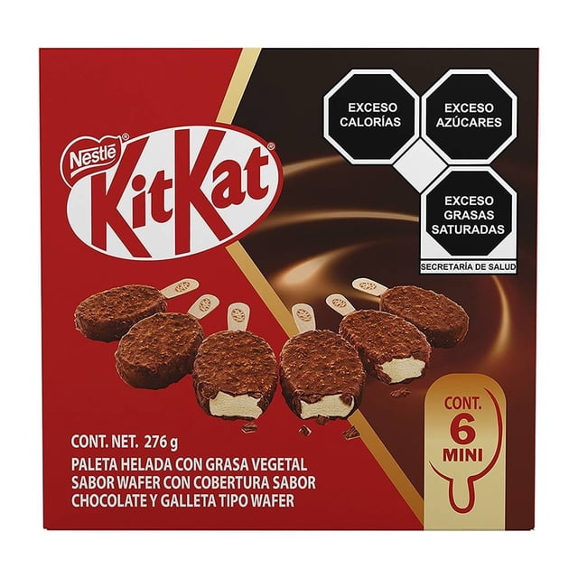 mini paletas heladas nestlé kit kat sabor wafer cubierta de chocolate 6 pzas — Caja frontal que muestra seis paletas mini redondas con cobertura crujiente de chocolate y trozos de galleta; cortes dejan ver relleno cremoso color vainilla. Fondo rojo y marrón con logo KitKat, sellos de advertencia nutricional en negro arriba a la derecha y leyenda "CONT. 6 MINI". Multipack ideal como snack para compartir.